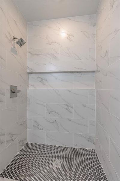 Bathroom featuring a tile shower