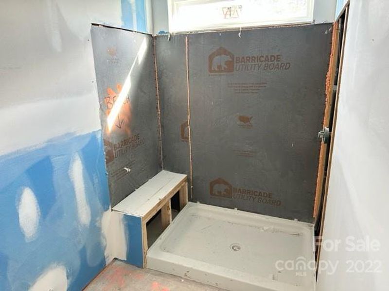 master suite walk in shower with bench