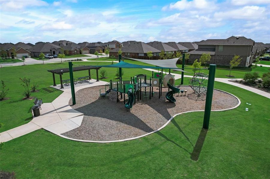 View of home's community with a pergola, a playground, and a lawn