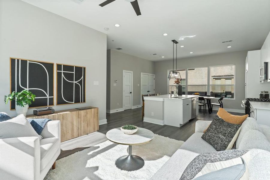 Living room featuring sink, dark hardwood / wood-style floors, and ceiling fan