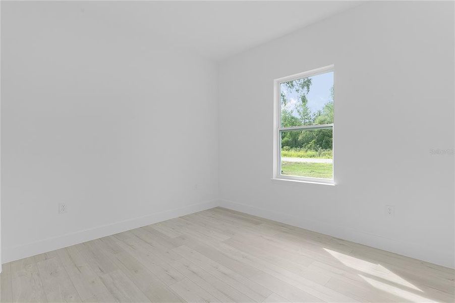 Bedroom 3 with window to the side of the house