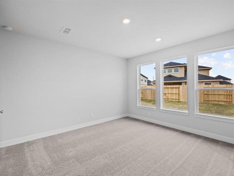 Another angle of the primary bedroom located on the first floor.