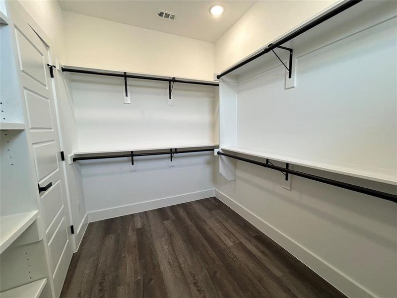 Walk in closet featuring dark wood-type flooring