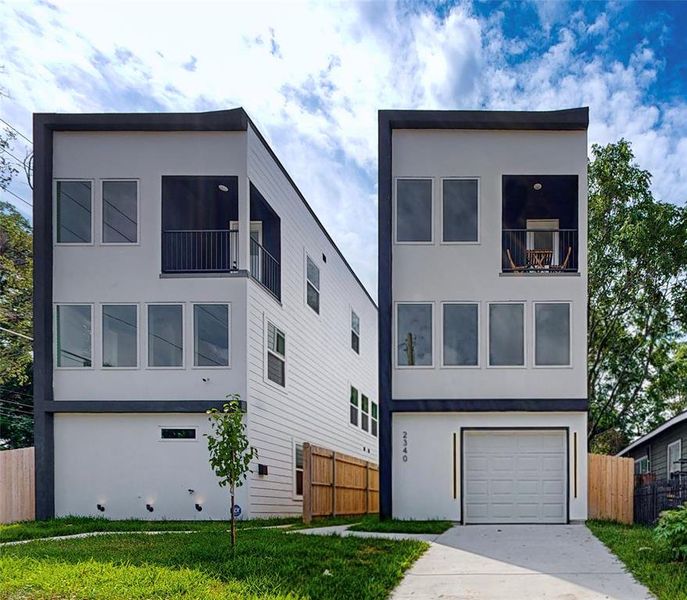 Contemporary house with a front lawn and a garage