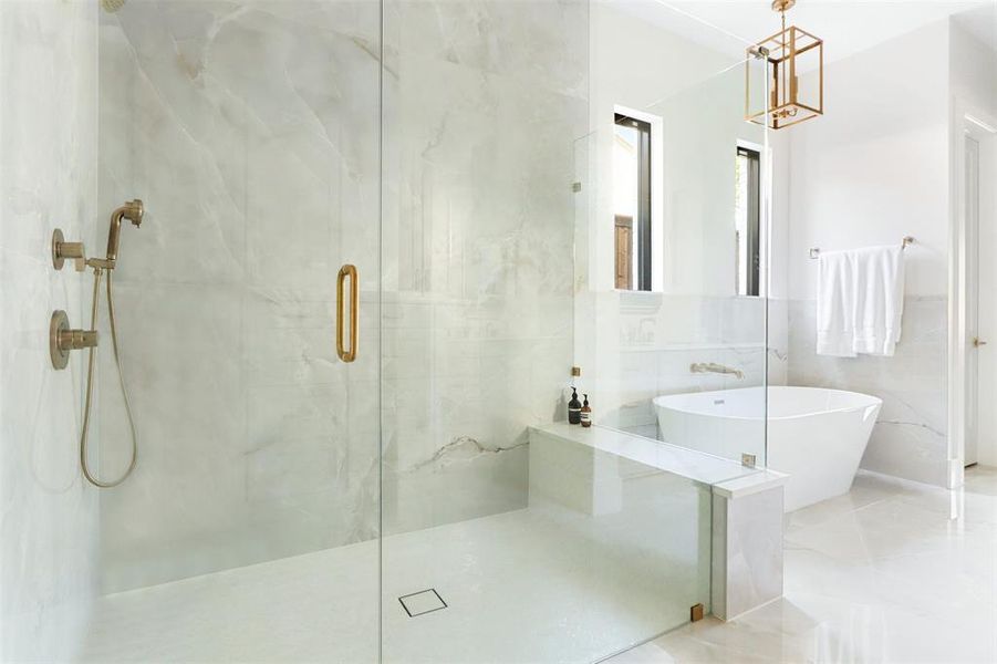 Bathroom featuring tile walls and independent shower and bath