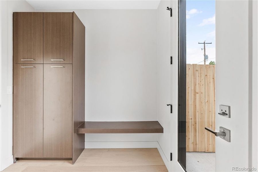 Fantastic bench and custom cabinetry at owner's entrance for easy transitions to/from the 2-car detached garage.