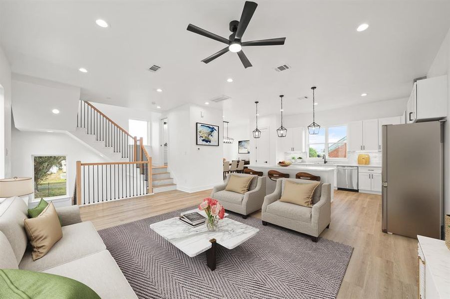 Virtually Staged: Fantastic open layout between the living, kitchen, and dining spaces. Photos are from a similar unit in the development.