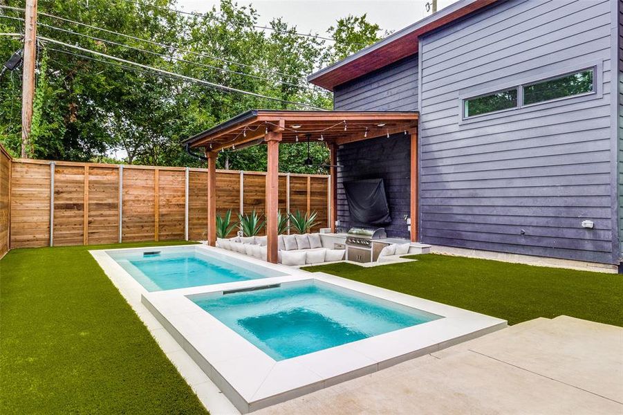 View of pool featuring an in ground hot tub, a yard, and a patio area