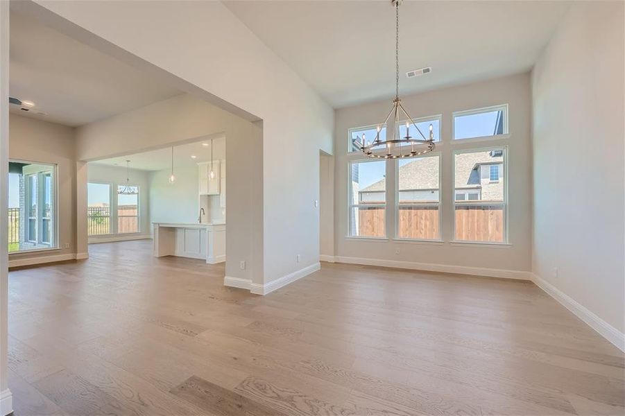 Unfurnished dining area featuring light hardwood / wood-style floors and plenty of natural light