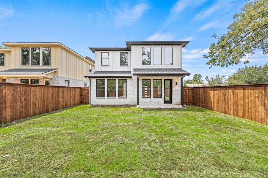 Back of house featuring a lawn