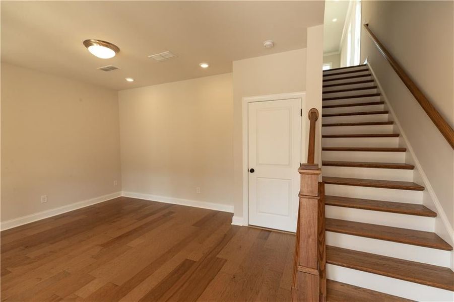 As you enter the first floor of the Benton home you are greeted with this media room with tons of natural light pouring. Could be an office space or additional living space! Not actual home.