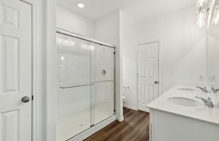 Elegant owner's bathroom with oversized shower*real home pictured