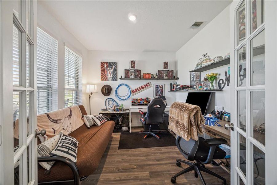 Versatile home office/study room with plenty of natural light, perfect for remote work, study sessions, or a quiet retreat.