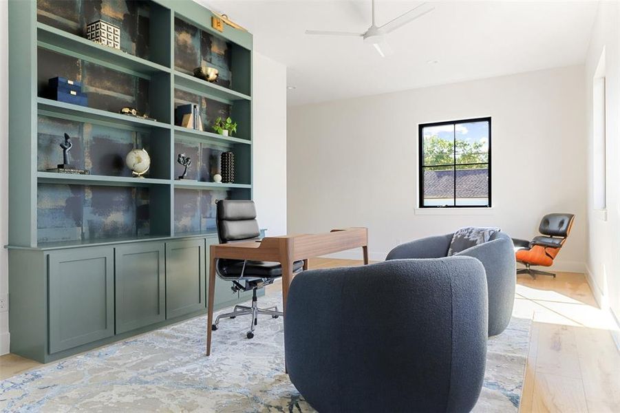 Home office with ceiling fan and light hardwood / wood-style flooring