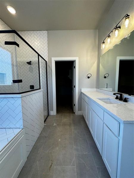 Bathroom with vanity and a shower with shower door