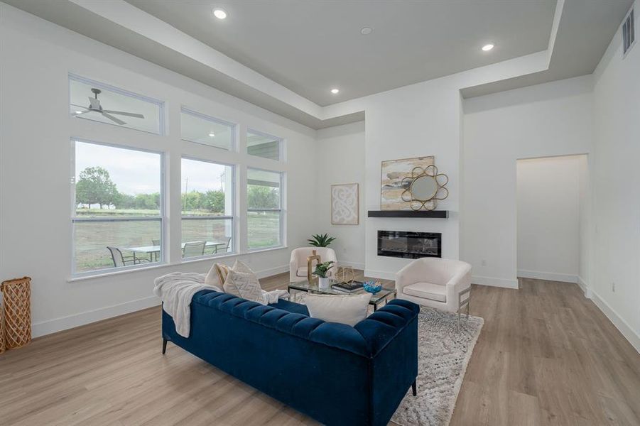 Living room featuring light wood flooring and ceiling fan