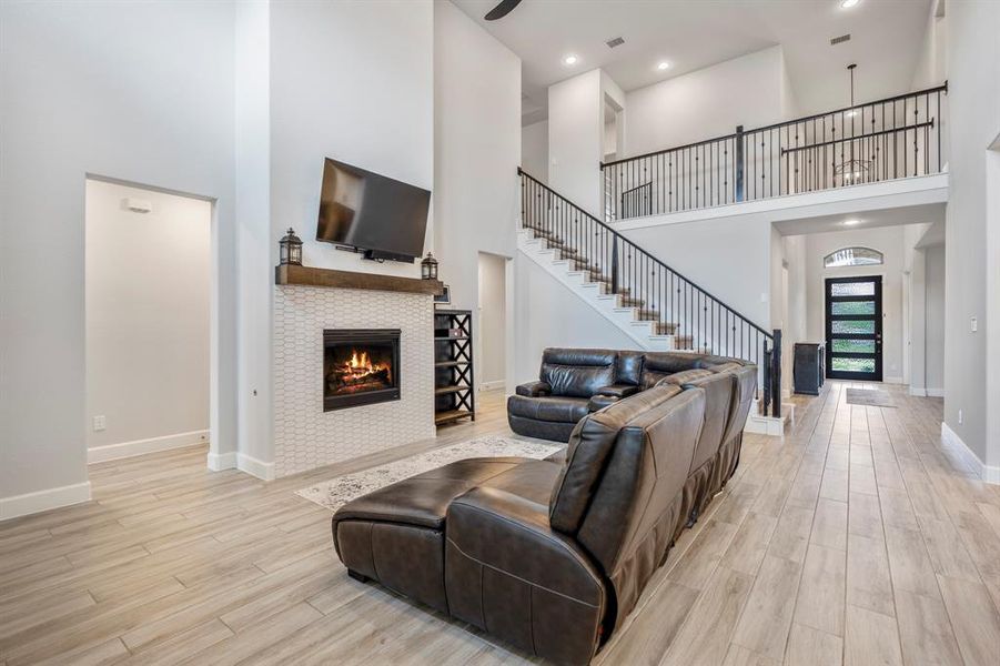 Whether it's a simple night in or entertaining family and friends, this home has ample open space for everyone to enjoy! You'll love cozying up by the fireplace featuring a modern tile surround and stained wood mantle.