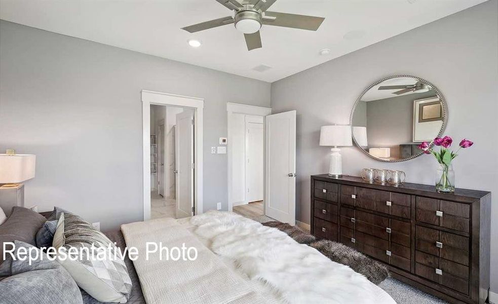 Bedroom with ceiling fan and hardwood / wood-style flooring