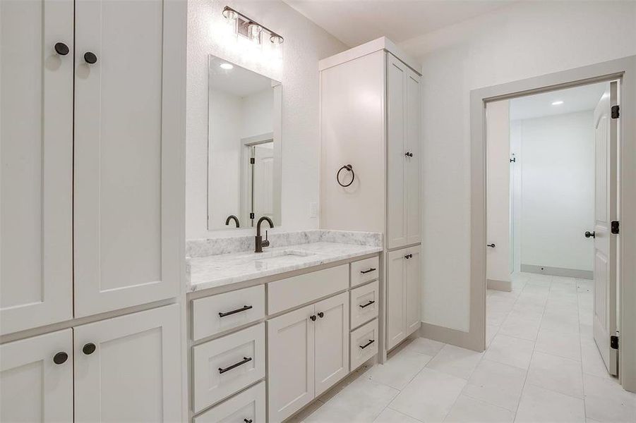 Bathroom featuring tile patterned floors and vanity