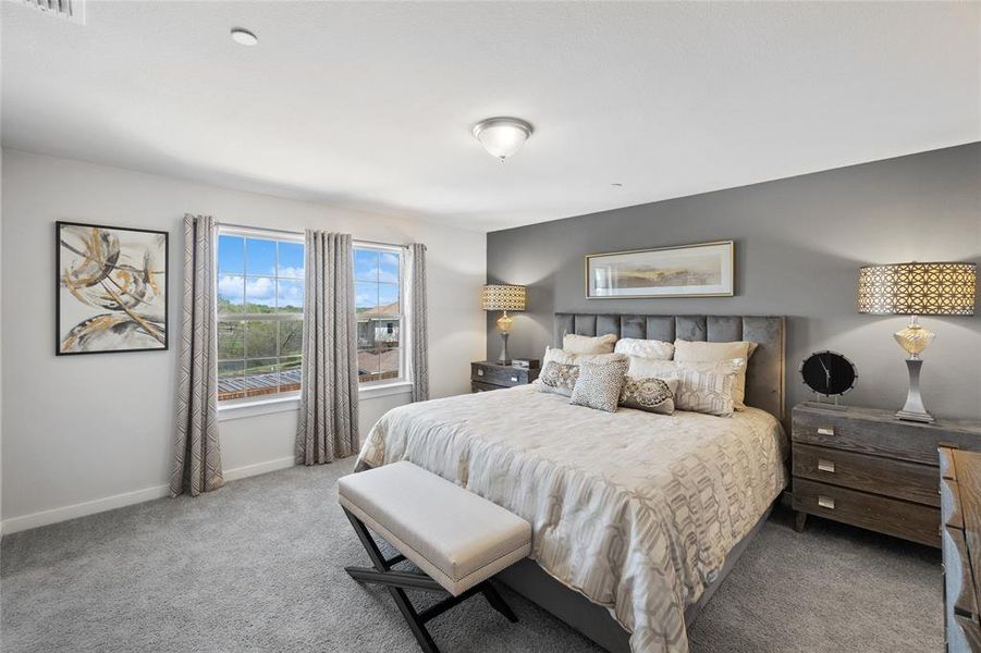 Bedroom featuring light colored carpet