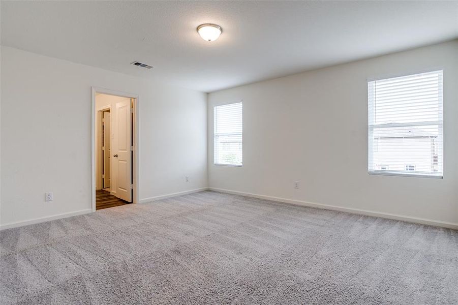 Carpeted spare room with plenty of natural light