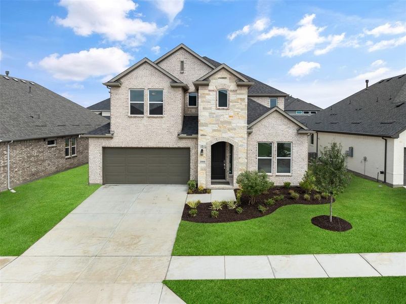 French provincial home with a garage and a front yard