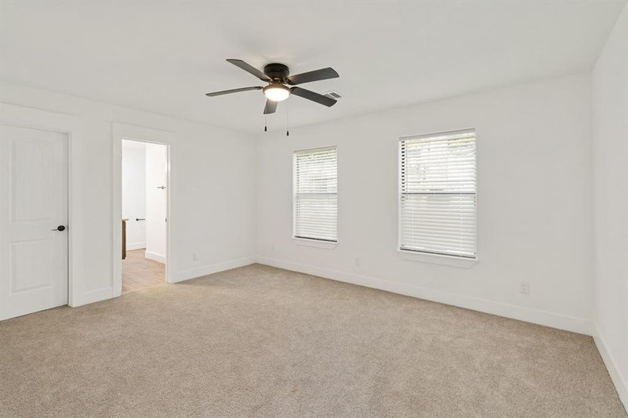 Primary En Suite featuring ceiling fan