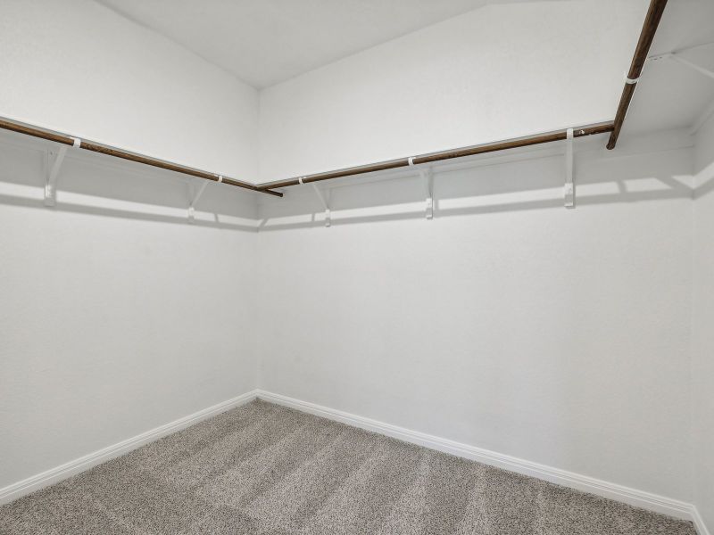 There's plenty of room for clothes and storage in this large primary bedroom closet.