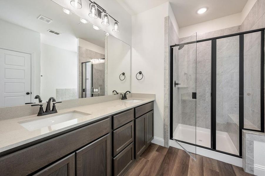 Primary Bath has Quartz, Undermount Dual sinks, Upgraded Fixtures, Closed Door shown is GIANT WALK IN CLOSET