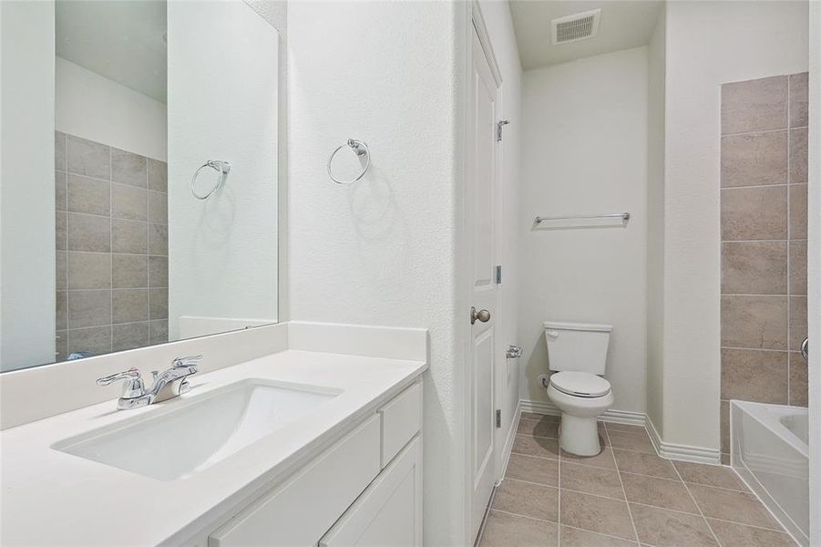 Bathroom with tile patterned flooring, toilet, and vanity