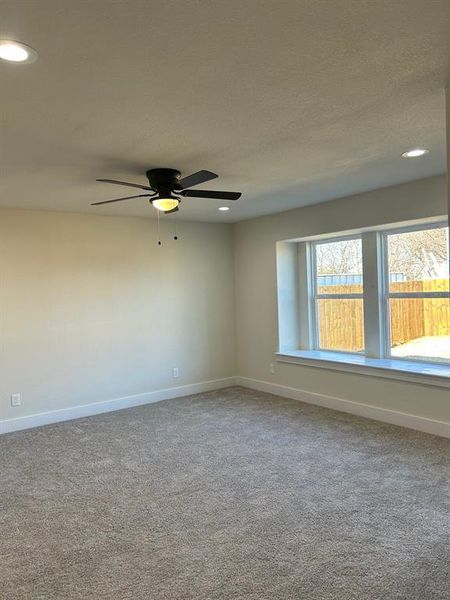 Primary bedroom, carpeted floor and ceiling fan