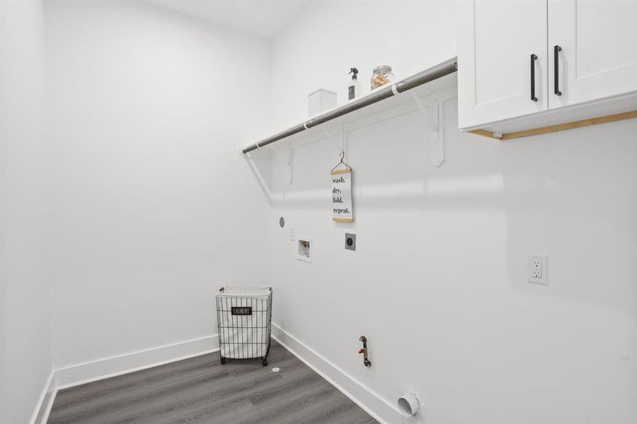 Laundry room with shelving and built in cabinets.