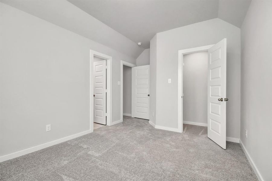 Generously sized secondary bedrooms featuring spacious closets, soft and inviting carpeting underfoot, large windows allowing plenty of natural light, and the added touch of privacy blinds for your personal retreat. Sample photo of completed home with similar floor plan. As-built interior colors and selections may vary.