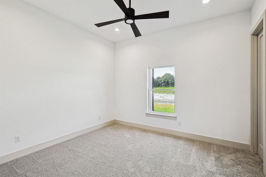 Unfurnished room with carpet flooring and ceiling fan