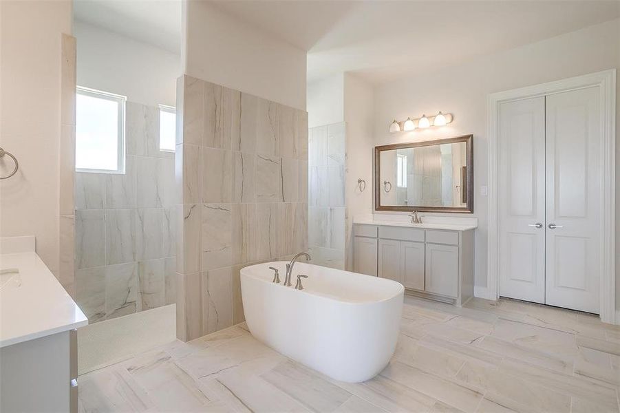 Bathroom with vanity, tile walls, a bath, and tile patterned floors