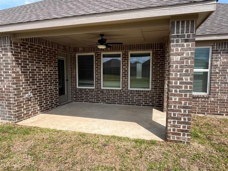 The covered back patio features stylish, modern ceiling fan and is the perfect size for outdoor entertaining and relaxing while enjoying your backyard.