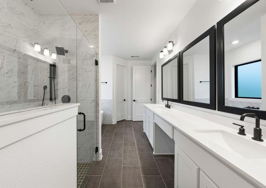 The gorgeous master bathroom has a giant vanity space that has two sinks and vanity space.