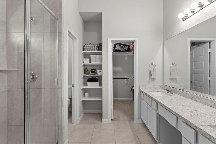 Dpuble vanity primary bathroom with spacious shower