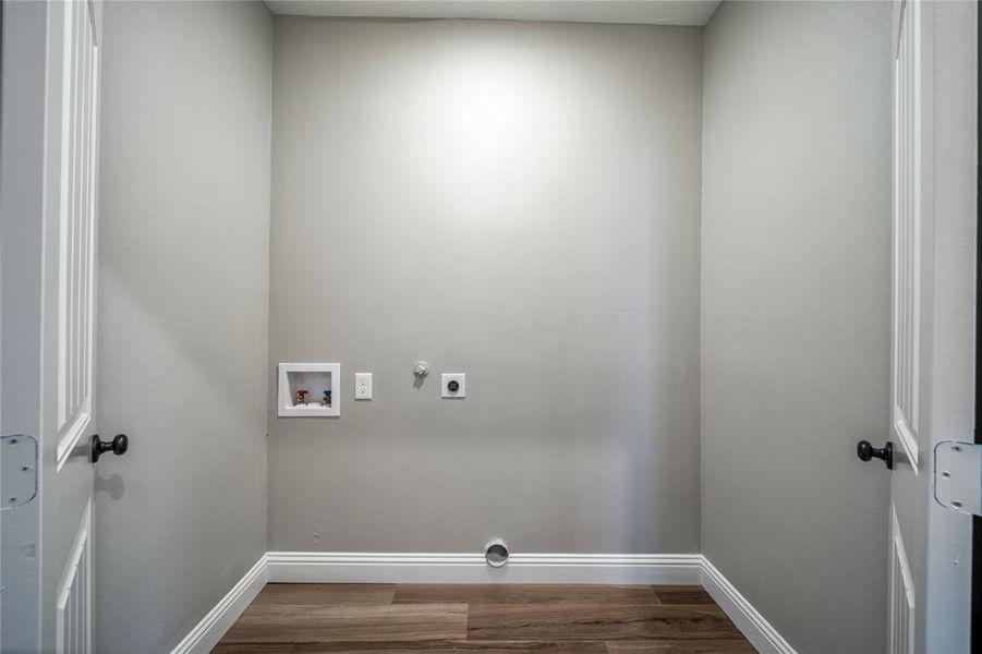 Washroom featuring hookup for a dryer, electric dryer hookup, hardwood / wood-style flooring, and washer hookup