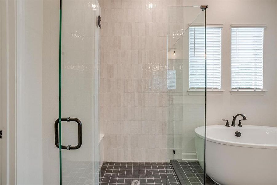Bathroom with independent shower and bath and tile patterned flooring