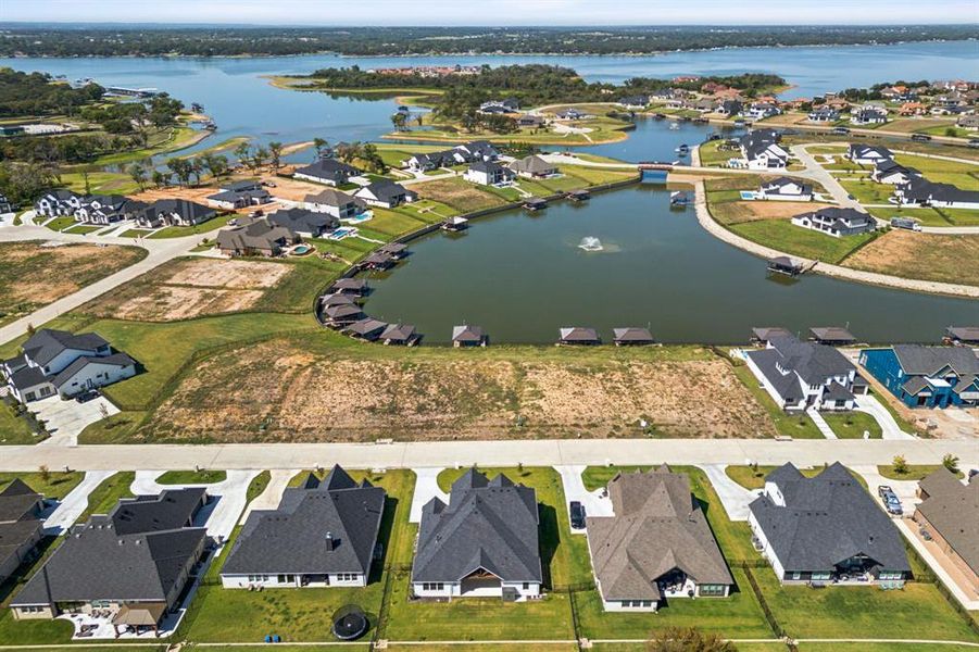 Birds eye view of property with a water view