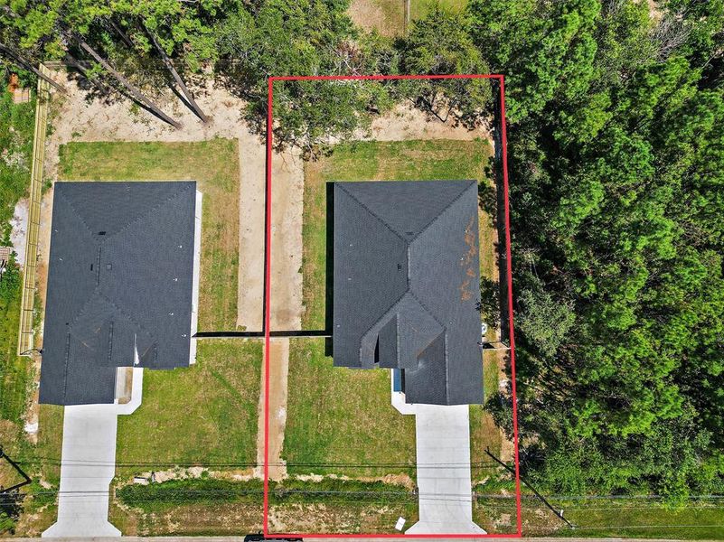 The aerial view showcases the beautiful natural surroundings, mature trees providing privacy. The setting offers a perfect blend of tranquility and accessibility.