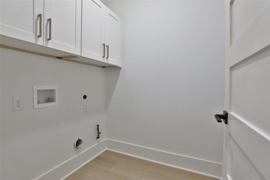 Third floor laundry room with loads of cabinet storage.