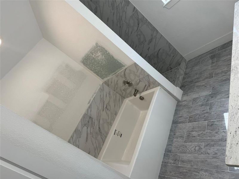 Details featuring a tile shower and tile patterned flooring