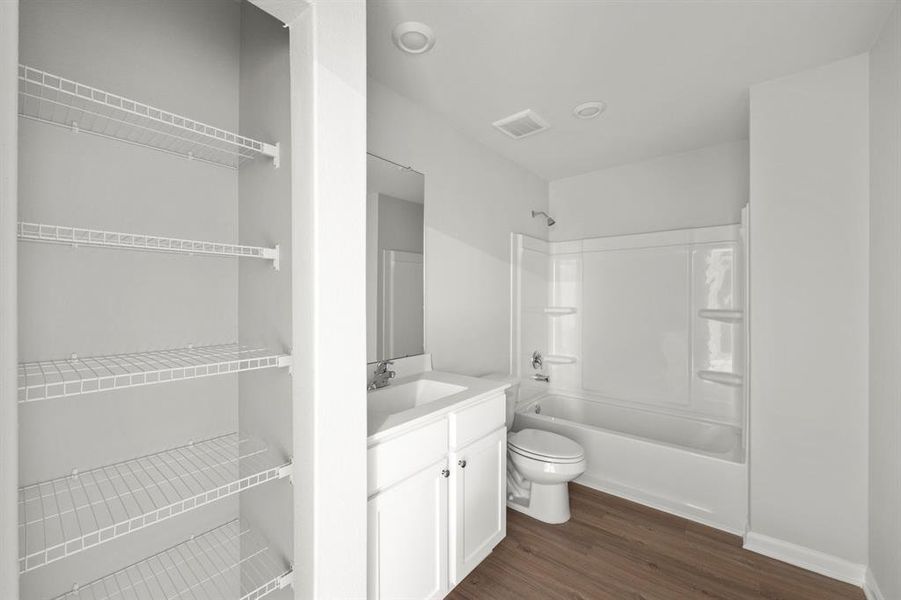 The secondary bathroom, located on the second floor of the home.
