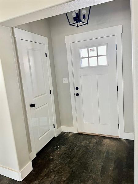 Entryway featuring a notable chandelier and dark hardwood / wood-style floors