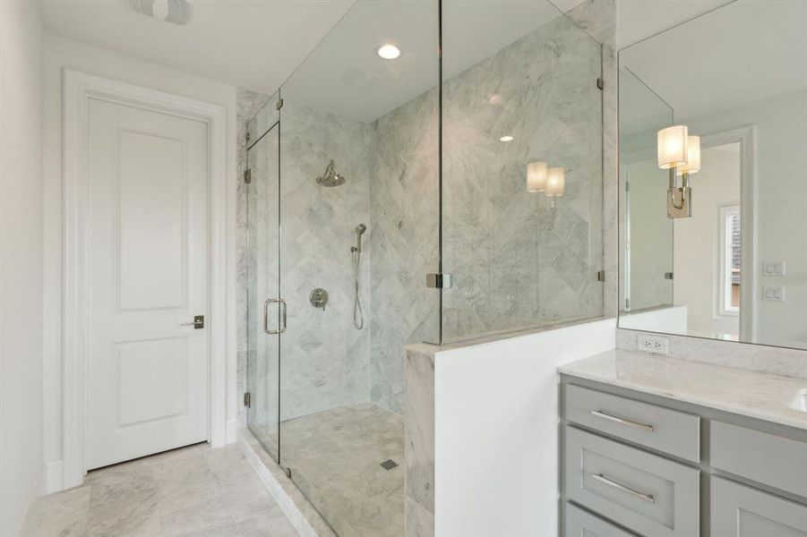 Primary bathroom with walk in shower and vanity