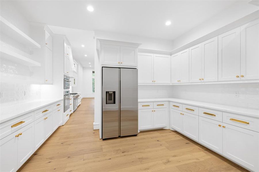 Yes this is the pantry!!! The Builder has already installed a secondary Samsung fridge. Pull out drawers in the pantry storage and soft close cabinetry are featured.