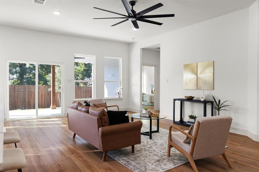 Living room with hardwood / wood-style floors and ceiling fan