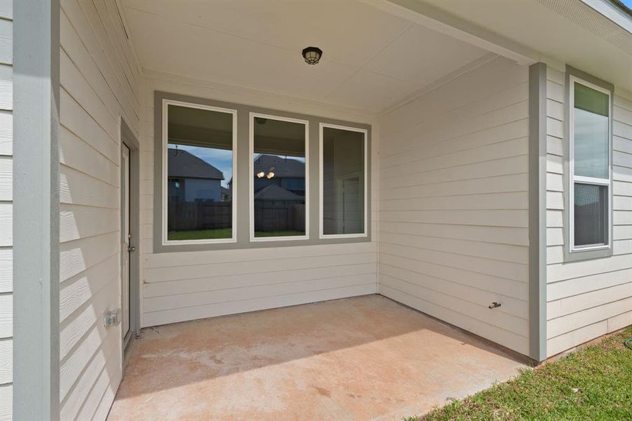 The covered patio is generously sized, providing ample space for various outdoor activities.